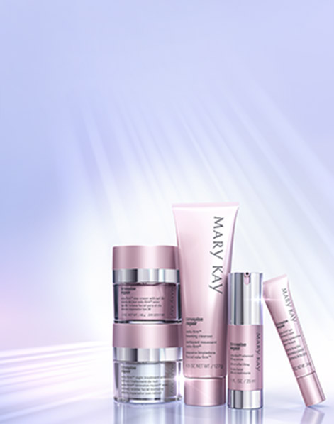 The Mary Kay TimeWise Repair Volu-Firm Set is shown in front of a purple background streaked with light. 