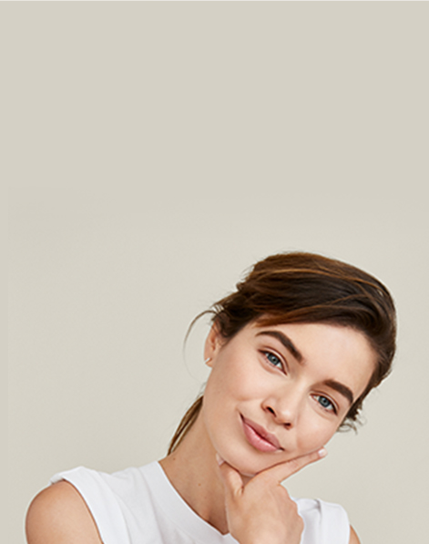 A picture of a smiling redheaded white woman in her twenties with glowing skin