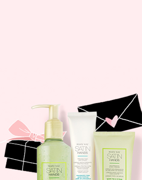 White Tea and Citrus Satin Hands Pampering Set from Mary Kay paired with pink and black illustrations of a gift box and envelope against a light pink background.
