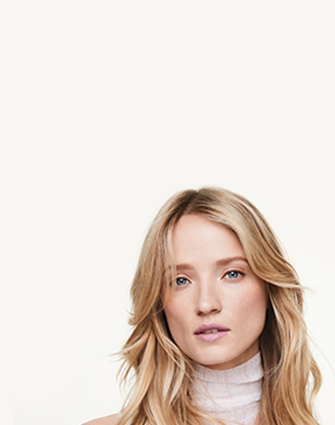 Close up of skin-focused model against a neutral background. 