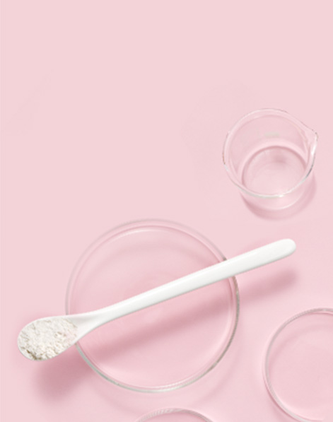 Scientific glassware and accessories representing Mary Kay skin care against pink background.