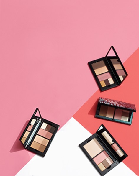 Four filled Mary Kay Perfect Palettes against a pink, white and coral background.