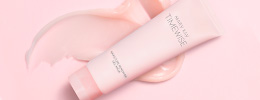 Pink tube of TimeWise® Moisture Renewing Gel Mask with product rub on a pink background