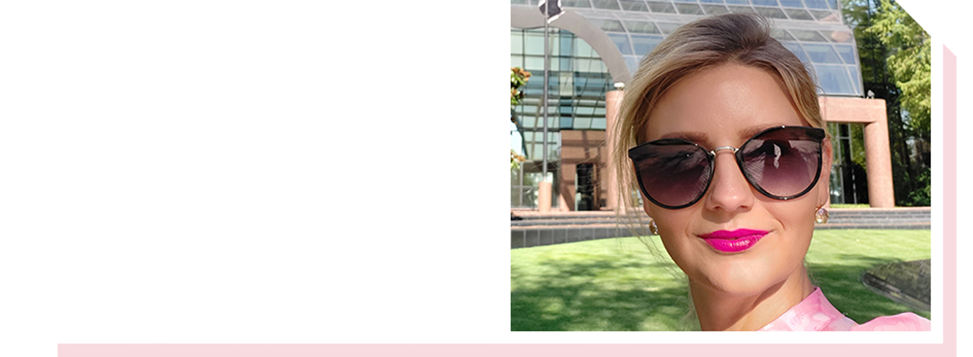 Image of woman with slight smile and wearing sunglasses