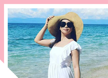  Image of woman on the beach wearing a hat and sunglasses