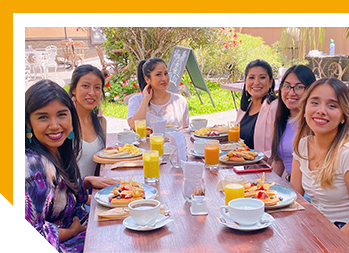 Image of women sitting at a long table