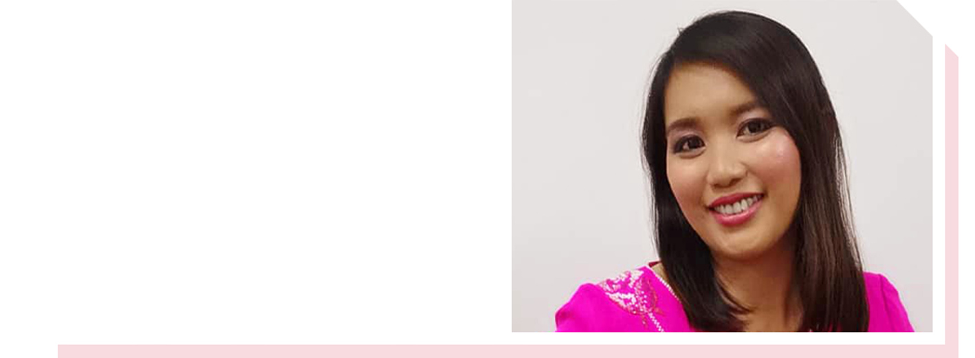 Image of woman in pink top smiling at camera