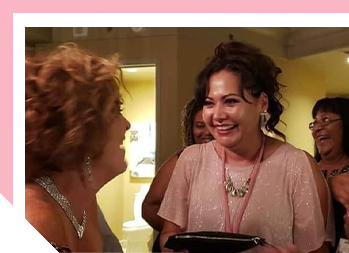 Image of two women smiling at each other