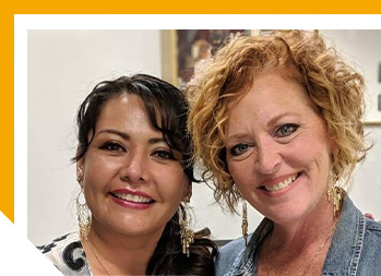 Image of two women smiling at camera