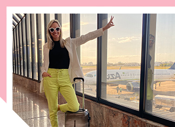 Image of smiling woman next to big windows