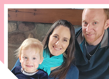 Image of a man, woman and child smiling