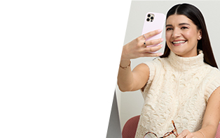 Medium-skinned woman holding up a phone with the screen facing towards her