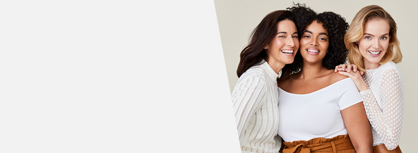 A picture of a mature Latina, a curvy black woman, and a blonde white woman with glowing skin smiling and laughing