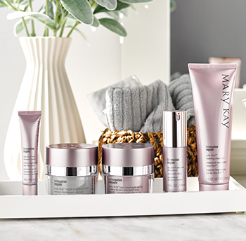 A picture of TimeWise Repair eye cream in a purple tube, night cream in a silver and purple jar, day cream with SPF sunscreen in a purple jar, advanced lifting serum in a purple and silver bottle and foaming cleanser in a purple tube on a counter top