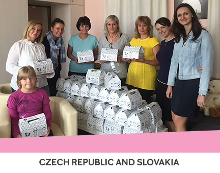 Mary Kay Czech Republic/Slovakia posing with breakfasts served at a temporary children’s home.