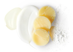 Mary Kay Naturally Exfoliating Powder spill, moisturizing stick slices and creamy, white purifying cleanser smear