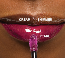 Three shades of new Mary Kay Unlimited Lip Gloss, one each in cream, pearl and shimmer finishes on dark bronze skin. 