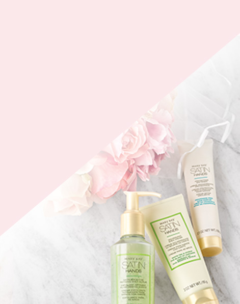 White Tea and Citrus Satin Hands Pampering Set from Mary Kay styled with flowers against marble background.