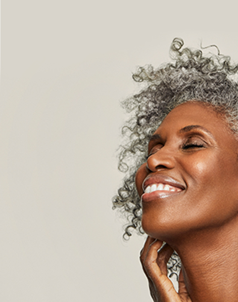 Smiling model representing benefits of Mary Kay Clinical Solutions Retinol 0.5 Set.