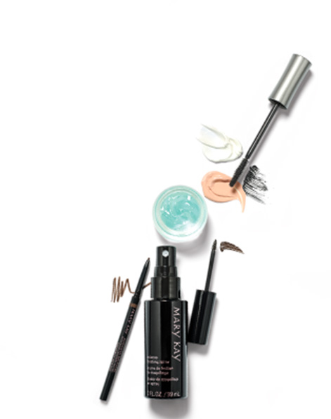 Product smears, Indulge Soothing Eye Gel, a mascara wand, Mary Kay Precision Brow Liner, Mary Kay Volumizing Brow Tint and Mary Kay Makeup Finishing Spray are all compiled together against a white background.