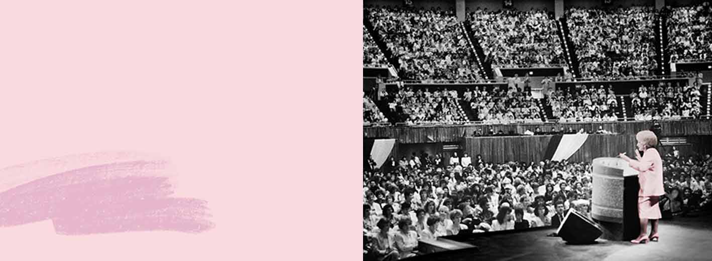 Mary Kay Ash stands at a podium in front of thousands of women at Mary Kay’s annual Seminar, a gathering of the independent sales force.