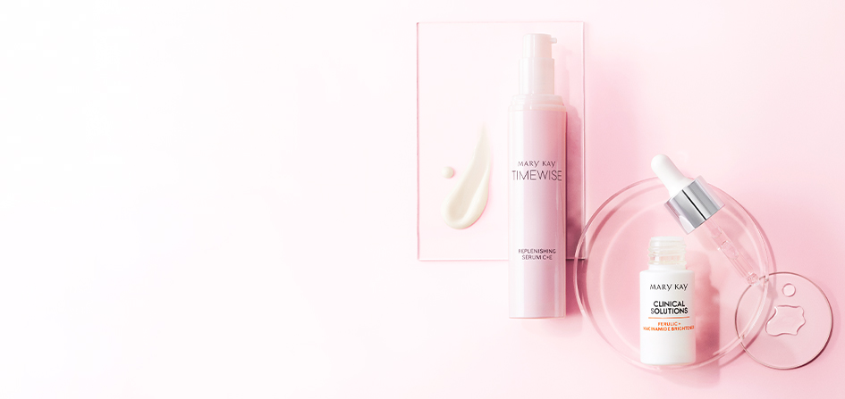 Best-in-Brightness Bundle styled with product rubs and droplets against clear geometric containers and light pink background.