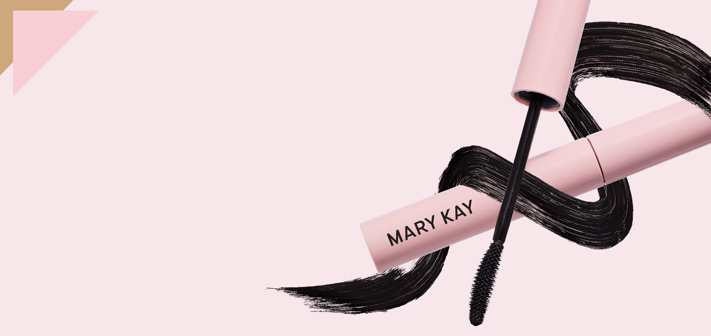 Full Mary Kay Great Heights Mascara surrounded by a mascara wand and mascara swatch on a pale pink background